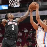 
              Oklahoma City Thunder forward Jeremiah Robinson-Earl, right, shoots as Houston Rockets guard Kevin Porter Jr. (3) defends during the first half of an NBA basketball game, Monday, Nov. 29, 2021, in Houston. (AP Photo/Eric Christian Smith)
            