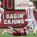 
              Louisiana-Monroe wide receiver Boogie Knight (17) escapes the grasp of Louisiana-Lafayette safety Brandon Bishop (25) for a touchdown in the first half of an NCAA college football game in Lafayette, La., Saturday, Nov. 27, 2021. (AP Photo/Matthew Hinton)
            