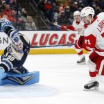 
              Detroit Red Wings forward Dylan Larkin, front right, scores a goal past Columbus Blue Jackets goalie Elvis Merzlikins during the first period of an NHL hockey game in Columbus, Ohio, Monday, Nov. 15, 2021. (AP Photo/Paul Vernon)
            