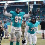 
              Miami Dolphins defensive end Emmanuel Ogbah (91) and nose tackle Adam Butler (70) celebrate at the end of an NFL football game against the Baltimore Ravens, Thursday, Nov. 11, 2021, in Miami Gardens, Fla. The Dolphins defeated the Ravens 22-10. (AP Photo/Wilfredo Lee)
            
