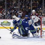 
              Colorado Avalanche's Nazem Kadri, left, scores against Vancouver Canucks goalie Thatcher Demko during the third period of an NHL hockey game Wednesday, Nov. 17, 2021, in Vancouver, British Columbia. (Darryl Dyck/The Canadian Press via AP
            