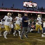 
              Notre Dame coach Brian Kelly, center, runs onto the field for the team's NCAA college football game against Stanford in Stanford, Calif., Saturday, Nov. 27, 2021. (AP Photo/Jed Jacobsohn)
            