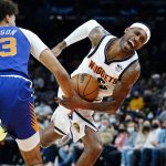
              Denver Nuggets forward Will Barton, right, gets fouled as he drives past Phoenix Suns forward Cameron Johnson (23) during the first half of an NBA basketball game Sunday, Nov. 21, 2021, in Phoenix. (AP Photo/Ross D. Franklin)
            
