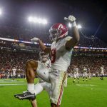 
              Alabama wide receiver John Metchie III (8) celebrates after scoring during the fourth overtime of an NCAA college football game to defeat Auburn 24-22 Saturday, Nov. 27, 2021, in Auburn, Ala. (AP Photo/Butch Dill)
            
