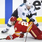 
              San Jose Sharks' Tomas Hertl, right, takes down Calgary Flames' Blake Coleman during the first period of an NHL hockey game, Tuesday, Nov. 9, 2021 in Calgary, Alberta. (Jeff McIntosh/The Canadian Press via AP)
            