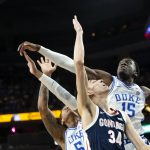 
              Gonzaga center Chet Holmgren (34) has his shot blocked as Duke forward Paolo Banchero (5) and center Mark Williams (15) defend during the first half of an NCAA college basketball game Friday, Nov. 26, 2021, in Las Vegas. (AP Photo/Ellen Schmidt)
            