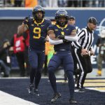 
              West Virginia wide receivers Isaiah Esdale (9) and Winston Wright Jr. (1) celebrate after a touchdown against Texas during the first half of an NCAA college football game in Morgantown, W.Va., Saturday, Nov. 20, 2021. (AP Photo/Kathleen Batten)
            