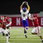 
              South Dakota State's Jadon Janke (9) jumps and catches a pass against South Dakota defenders during an NCAA college football game, Saturday, Nov. 13, 2021, at the DakotaDome in Vermillion, S.D. (Erin Woodiel/The Argus Leader via AP)
            