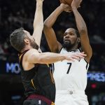 
              Brooklyn Nets' Kevin Durant (7) shoots over Cleveland Cavaliers' Kevin Love during the second half of an NBA basketball game, Monday, Nov. 22, 2021, in Cleveland. (AP Photo/Tony Dejak)
            