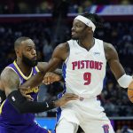 
              Detroit Pistons forward Jerami Grant (9) is defended by Los Angeles Lakers forward LeBron James (6) during the first half of an NBA basketball game, Sunday, Nov. 21, 2021, in Detroit. (AP Photo/Carlos Osorio)
            