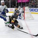 
              Vegas Golden Knights center Chandler Stephenson (20) and Vancouver Canucks defenseman Oliver Ekman-Larsson (23) look for the puck during the second period of an NHL hockey game Saturday, Nov. 13, 2021, in Las Vegas. (AP Photo/David Becker)
            
