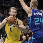 
              Charlotte Hornets center Mason Plumlee (24) guards Indiana Pacers forward Domantas Sabonis (11) during the first half of an NBA basketball game in Charlotte, N.C., Friday, Nov. 19, 2021. (AP Photo/Jacob Kupferman)
            