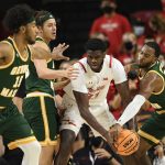 
              Maryland forward Qudus Wahab (33) is pressured by George Mason guard DeVon Cooper, right, forward Josh Oduro, second from the left, and guard D'Shawn Schwartz, left, during the first half of an NCAA college basketball game Wednesday, Nov. 17, 2021, in College Park, Md. (AP Photo/Nick Wass)
            