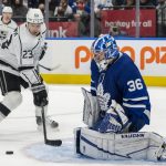 
              Toronto Maple Leafs goaltender Jack Campbell (36) makes a save without his stick against Los Angeles Kings right wing Dustin Brown (23) during first-period NHL hockey game action in Toronto, Monday, Nov. 8, 2021. (Frank Gunn/The Canadian Press via AP)
            