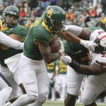 
              Baylor running back Abram Smith scores a touchdown past Texas Tech defensive lineman Jaylon Hutchings in the first half of an NCAA college football game Saturday, Nov. 27, 2021, in Waco, Texas. (AP Photo/Jerry Larson)
            