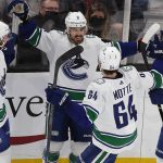 
              Vancouver Canucks' Conor Garland (8) celebrates his goal with teammates Kyle Burroughs (44), Tyler Motte (64) and Jason Dickinson (18) during the second period of an NHL hockey game against the Boston Bruins, Sunday, Nov. 28, 2021, in Boston. (AP Photo/Michael Dwyer)
            
