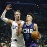 
              Charlotte Hornets guard LaMelo Ball (2) drives while defended by Los Angeles Clippers guard Luke Kennard (5) during the first half of an NBA basketball game Sunday, Nov. 7, 2021, in Los Angeles. (AP Photo/Ringo H.W. Chiu)
            