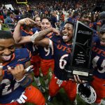 
              UTSA players celebrate with their conference trophy after their win over UAB in an NCAA college football game, Saturday, Nov. 20, 2021, in San Antonio. The win (AP Photo/Eric Gay)
            