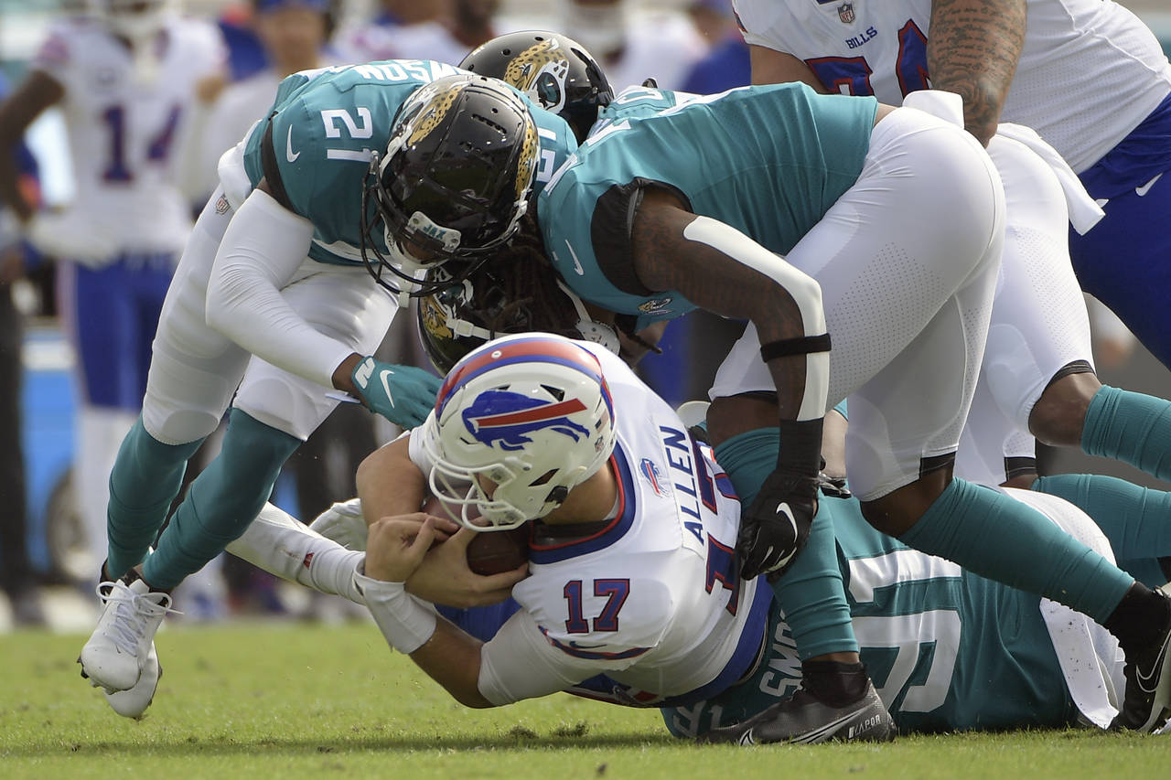 Buffalo Bills quarterback Josh Allen (17) is sacked by the Jacksonville Jaguars defense during the ...