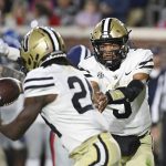 
              Vanderbilt quarterback Mike Wright (5) tosses the ball to running back Rocko Griffin (24) during the first half of an NCAA college football game in Oxford, Miss., Saturday, Nov. 20, 2021. (AP Photo/Thomas Graning)
            