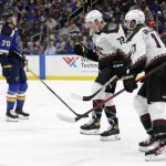 
              Arizona Coyotes' Travis Boyd (72) celebrates a goal by teammate Kyle Capobianco (75) as St. Louis Blues' Oskar Sundqvist (70) looks at a replay during the first period of an NHL hockey game Tuesday, Nov. 16, 2021 in St. Louis. (AP Photo/Tom Gannam)
            