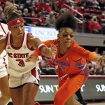 
              NC State's Kai Crutchfield, front left, battles Florida's Lavender Briggs, right, for the ball during the first half of an NCAA college basketball game, Sunday, Nov. 14, 2021 in Raleigh, N.C. (AP Photo/Karl B. DeBlaker)
            