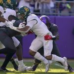 
              Baylor running back Abram Smith (7) is stopped for a loss by TCU defensive tackle Earl Barquet, right rear, and others in the first half of an NCAA college football game in Fort Worth, Texas, Saturday, Nov. 6, 2021. (AP Photo/Tony Gutierrez)
            