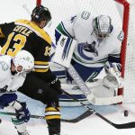 
              Vancouver Canucks' Jaroslav Halak (41) blocks a shot by Boston Bruins' Charlie Coyle (13) during the first period of an NHL hockey game, Sunday, Nov. 28, 2021, in Boston. (AP Photo/Michael Dwyer)
            
