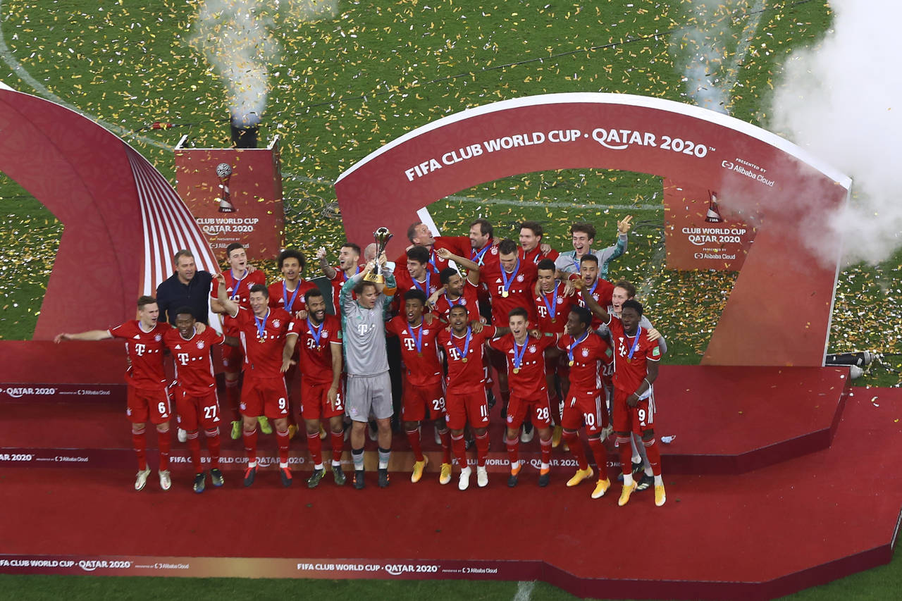 FILE - Bayern's goalkeeper Manuel Neuer holds up the trophy as celebrates with his teammates winnin...