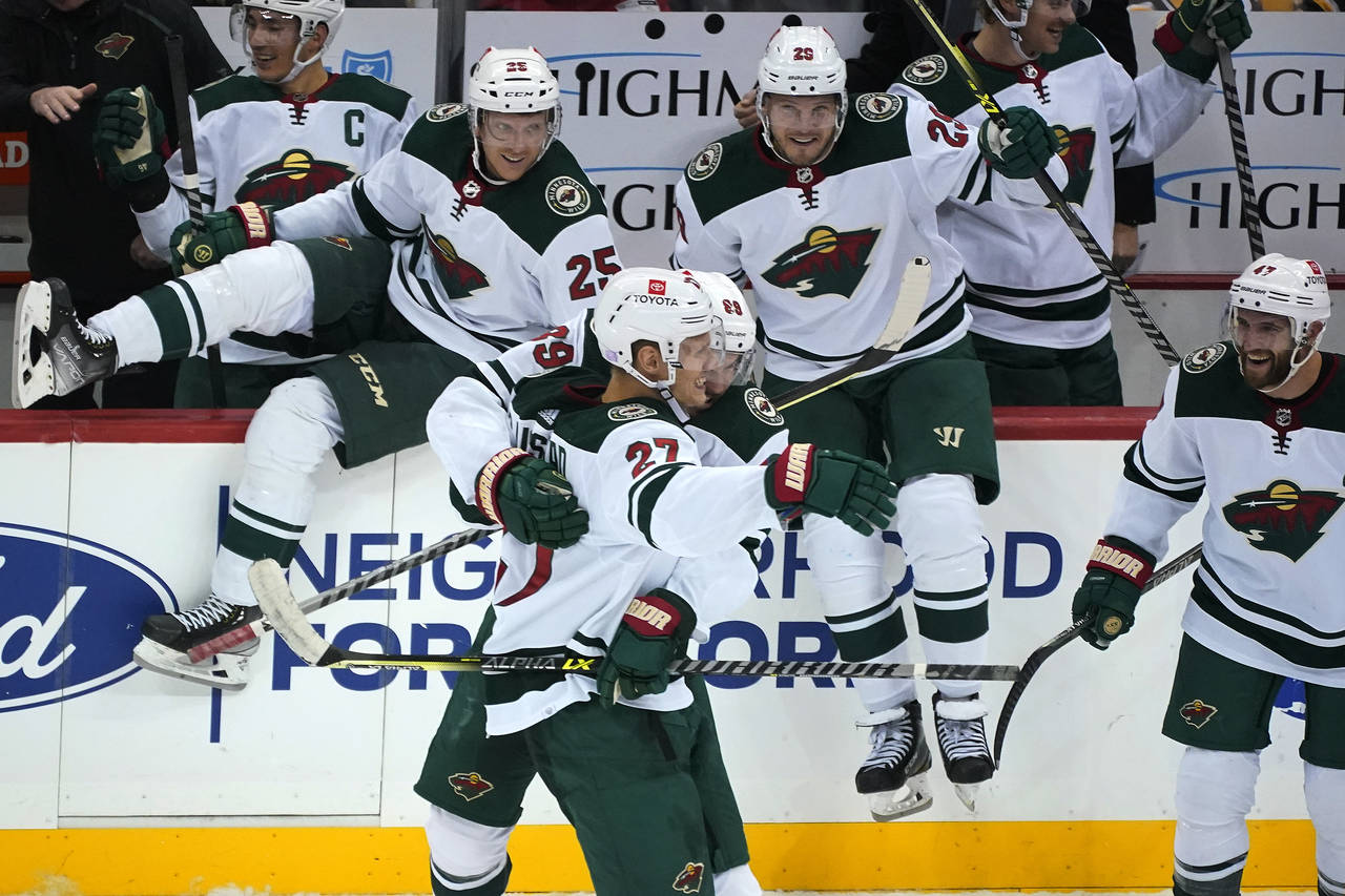 Minnesota Wild's Nick Bjugstad (27) is congratulated after scoring the winning goal in the shootout...