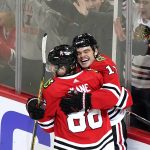 
              Chicago Blackhawks left wing Alex DeBrincat, right, celebrates with right wing Patrick Kane after scoring the game-winning goal against the St. Louis Blues during an overtime period of an NHL hockey game in Chicago, Friday, Nov. 26, 2021. The Chicago Blackhawks won 3-2 in overtime.(AP Photo/Nam Y. Huh)
            