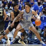 
              Duke's Paolo Banchero (5) handles the ball as Army's Jared Cross, left, defends during the first half of an NCAA college basketball game in Durham, N.C., Friday, Nov. 12, 2021. (AP Photo/Ben McKeown)
            