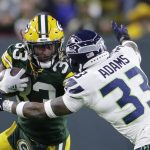
              Green Bay Packers' Aaron Jones tries to get past Seattle Seahawks' Jamal Adams during the first half of an NFL football game Sunday, Nov. 14, 2021, in Green Bay, Wis. (AP Photo/Aaron Gash)
            