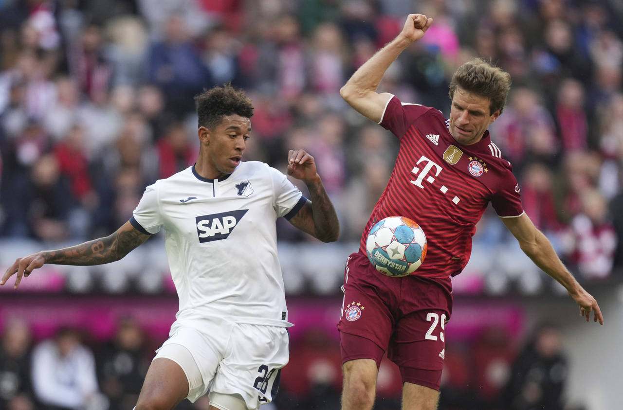 Hoffenheim's Chris Richards, left, challenges for the ball with Bayern's Thomas Mueller during the ...