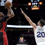 
              Portland Trail Blazers forward Norman Powell, left, shoots the ball over Philadelphia 76ers forward Georges Niang, right, during the second half of an NBA basketball game in Portland, Ore., Saturday, Nov. 20, 2021. The Trail Blazers won 118-111. (AP Photo/Steve Dykes)
            