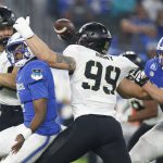 
              Air Force quarterback Haaziq Daniels, left foreground, fumbles the ball as Army defensive lineman Chris Frey (99)  rushes in the first half of an NCAA college football game in Arlington, Texas, Saturday, Nov. 6, 2021. Air Force recovered the fumble. (AP Photo/Tim Heitman)
            