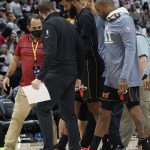 
              Miami Heat forward Markieff Morris, center, is escorted off the court following an altercation with Denver Nuggets center Nikola Jokic in the second half of an NBA basketball game Monday, Nov. 8, 2021, in Denver. The Nuggets won 113-96. (AP Photo/David Zalubowski)
            