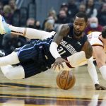 
              Orlando Magic's Terrence Ross (31) and Cleveland Cavaliers' Cedi Osman (16) battle for a loose ball in the first half of an NBA basketball game, Saturday, Nov. 27, 2021, in Cleveland. (AP Photo/Tony Dejak)
            
