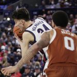 
              Gonzaga center Chet Holmgren, left, secures a rebound in front of Texas forward Timmy Allen during the second half of an NCAA college basketball game, Saturday, Nov. 13, 2021, in Spokane, Wash. Gonzaga won 86-74. (AP Photo/Young Kwak)
            