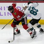 
              Chicago Blackhawks left wing Jujhar Khaira, left, controls the puck against San Jose Sharks left wing Matt Nieto during the first period of an NHL hockey game in Chicago, Sunday, Nov. 28, 2021. (AP Photo/Nam Y. Huh)
            
