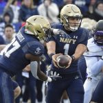 
              Navy quarterback Tai Lavatai hands off to James Harris II during the first quarter against East Carolina in an NCAA college football game Saturday, Nov. 20, 2021, in Annapolis, Md. (Paul W. Gillespie/The Baltimore Sun via AP)
            