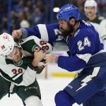 
              Tampa Bay Lightning defenseman Zach Bogosian (24) and Minnesota Wild right wing Ryan Hartman (38) fight during the first period of an NHL hockey game Sunday, Nov. 21, 2021, in Tampa, Fla. Both players were given major penalties. (AP Photo/Chris O'Meara)
            