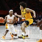 
              Tennessee guard Zakai Zeigler (5) passes the ball as he's defended by East Tennessee State guard Jordan King (2) during an NCAA college basketball game, Sunday, Nov. 14, 2021, in Knoxville, Tenn. (AP Photo/Wade Payne)
            