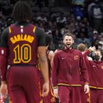 
              Cleveland Cavaliers' Darius Garland (10) walks off the court as forward Kevin Love, center, greets him in celebration in the second half of an NBA basketball game against the Dallas Mavericks in Dallas, Monday, Nov. 29, 2021. (AP Photo/Tony Gutierrez)
            