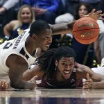 
              West Virginia forward Gabe Osabuohien (3) and Bellarmine guard Dylan Penn (13) vie for the ball during the second half of an NCAA college basketball game in Morgantown, W.Va., Tuesday, Nov. 30, 2021. (AP Photo/Kathleen Batten)
            