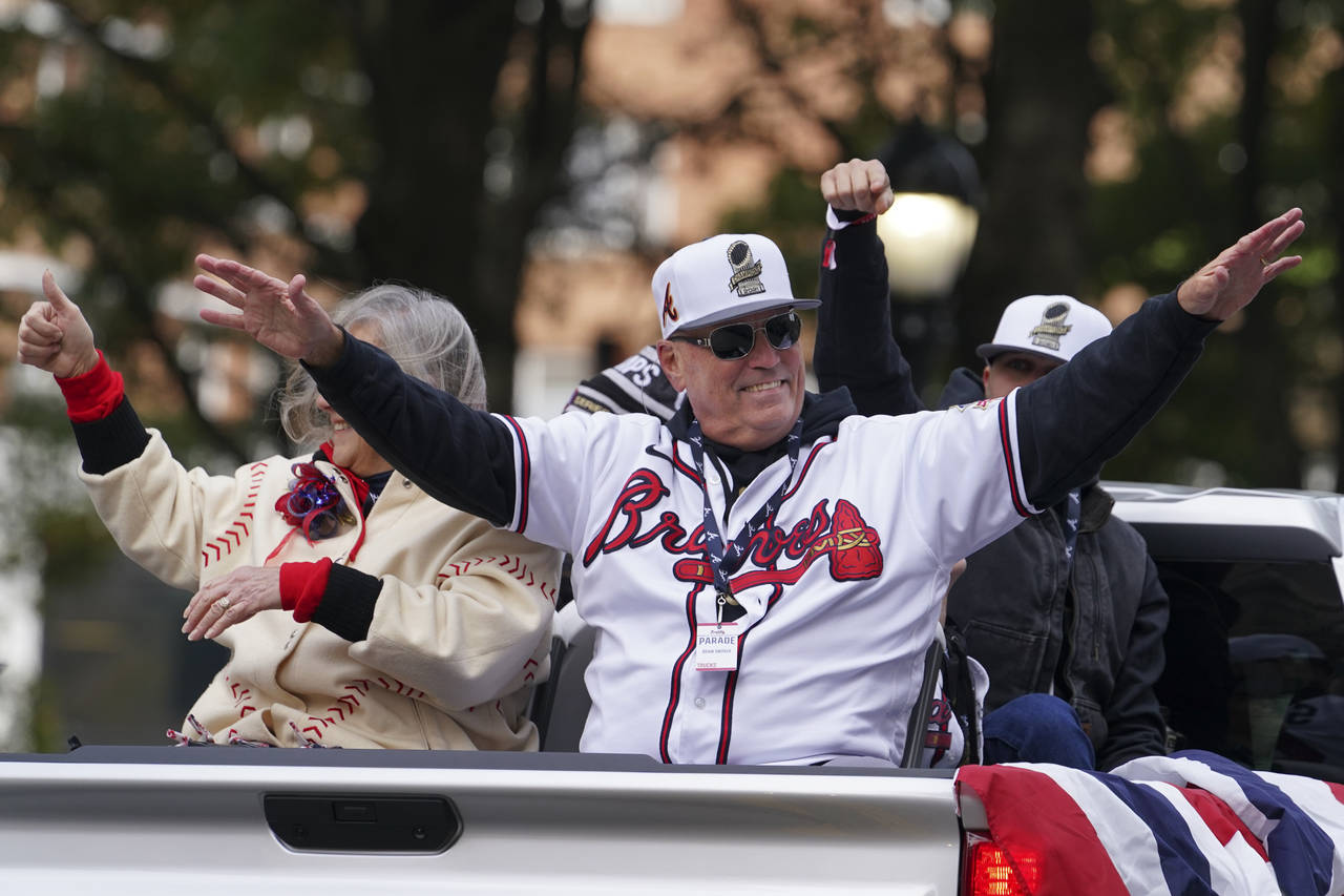 Atlanta Braves manager Brian Snitker celebrates the team's victory during a victory parade, Friday,...