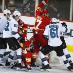 
              Calgary Flames' Milan Lucic, center, celebrates his goal as San Jose Sharks players crowd the net during the second period of an NHL hockey game, Tuesday, Nov. 9, 2021 in Calgary, Alberta. (Jeff McIntosh/The Canadian Press via AP)
            