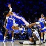 
              Philadelphia 76ers' Matisse Thybulle, left, goes flying after chasing after a loose ball against Orlando Magic's Mo Bamba during the first half of an NBA basketball game, Monday, Nov. 29, 2021, in Philadelphia. (AP Photo/Matt Slocum)
            