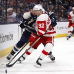 
              Detroit Red Wings forward Vladislav Namestnikov, right, reaches for the puck in front of Columbus Blue Jackets defenseman Andrew Peeke during the first period of an NHL hockey game in Columbus, Ohio, Monday, Nov. 15, 2021. (AP Photo/Paul Vernon)
            