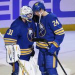 
              Buffalo Sabres goaltender Dustin Tokarski (31) and center Dylan Cozens (24) celebrate a 3-2 victory over the Edmonton Oilers following the third period of a NHL hockey game, Friday, Nov. 12, 2021, in Buffalo, N.Y. (AP Photo/Jeffrey T. Barnes)
            